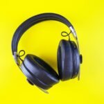 a pair of headphones on a yellow background